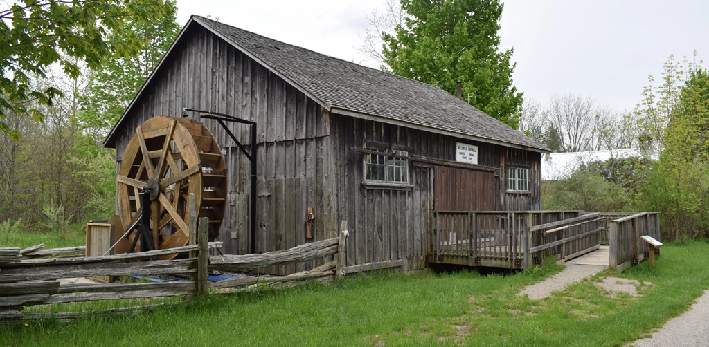 Old mill with water wheel on the front of the building